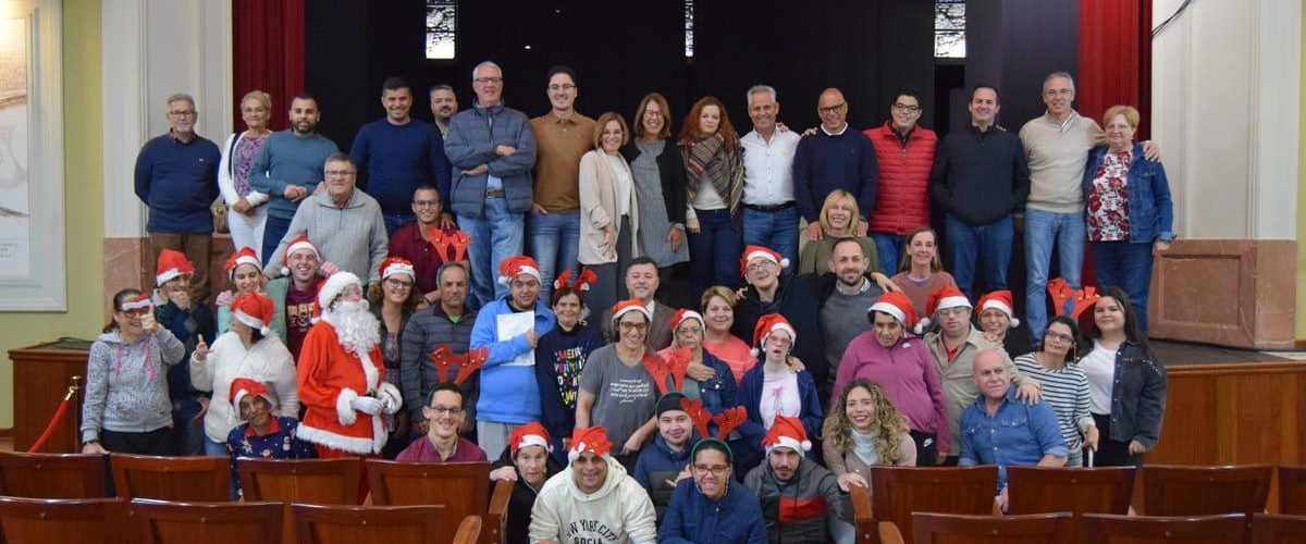 Los usuarios del Centro Ocupacional y el grupo de gobierno en la felicitacion mutua de Navidad en el Teatro Consistorial